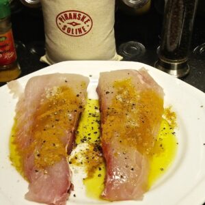 Marinate fish with oil, turmeric powder, salt and pepper